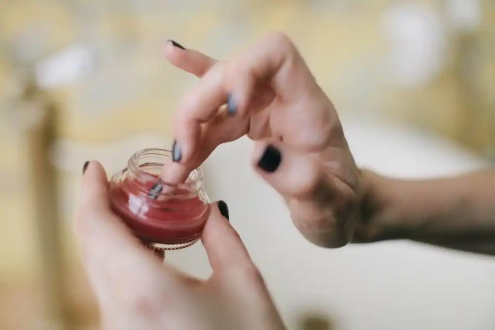 close-up-of-a-woman-s-finger-dipping-into-a-glass-container-3394198